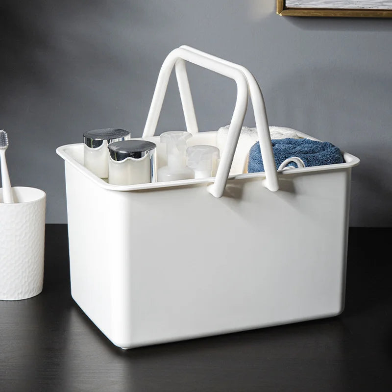 White portable shower caddy basket with built-in drainage holes for dorm or bathroom use.
