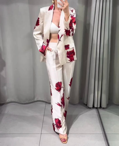 Stand out with UniVibe Shop’s floral blazer and pants set. Beige with bold red floral prints, perfect for work, events, or casual chic fashion. Shop UniVibe today.