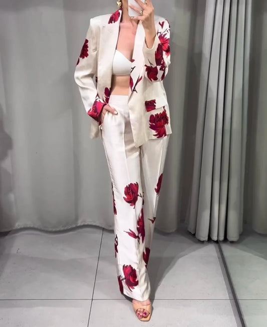 Stand out with UniVibe Shop’s floral blazer and pants set. Beige with bold red floral prints, perfect for work, events, or casual chic fashion. Shop UniVibe today.