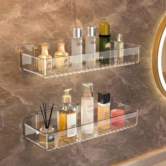 Clear glass shelves with skincare products on a marble wall.
